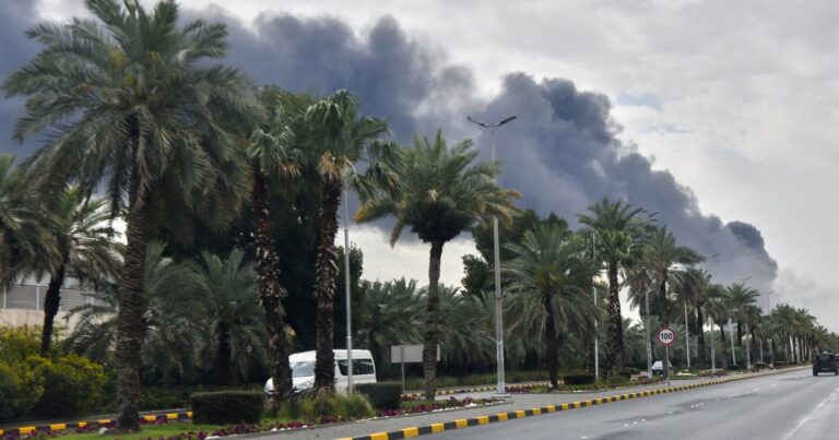 Bandera de Irán y logos de empresas tecnológicas como Apple y Google en un fondo que sugiere tensión geopolítica.