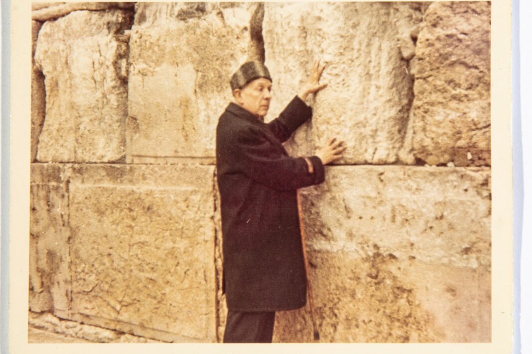 Jorge Luis Borges con gorro, abrigo y bastón frente al Muro de los Lamentos en Jerusalén, 1969