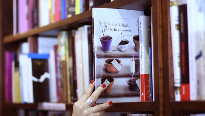 Persona hojeando un libro en una librería