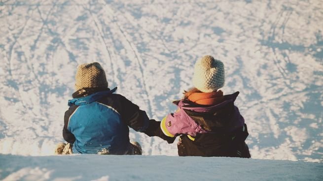 Personas en un aeropuerto con equipaje de vacaciones de invierno